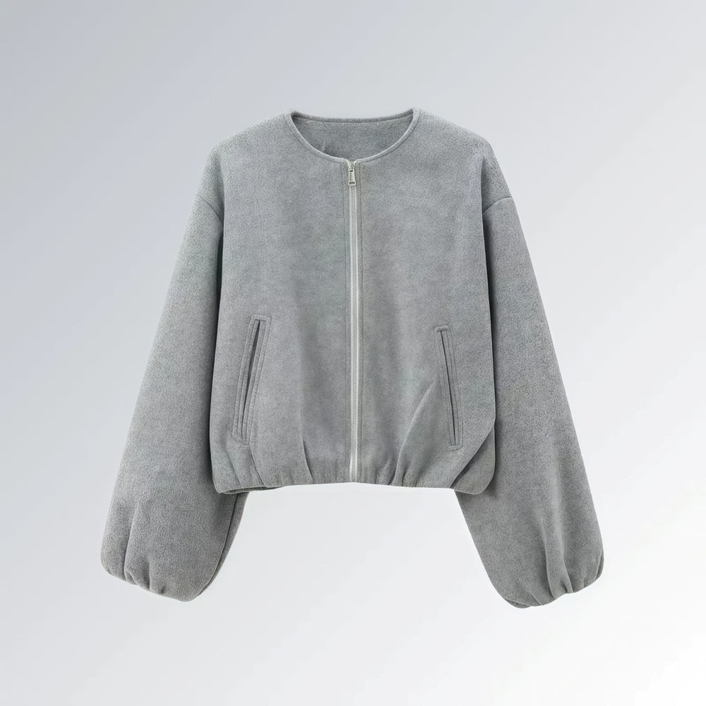 Jaqueta feminina cinza com zíper metálico, mangas bufantes e bolsos frontais, estilo casual streetwear para o outono.