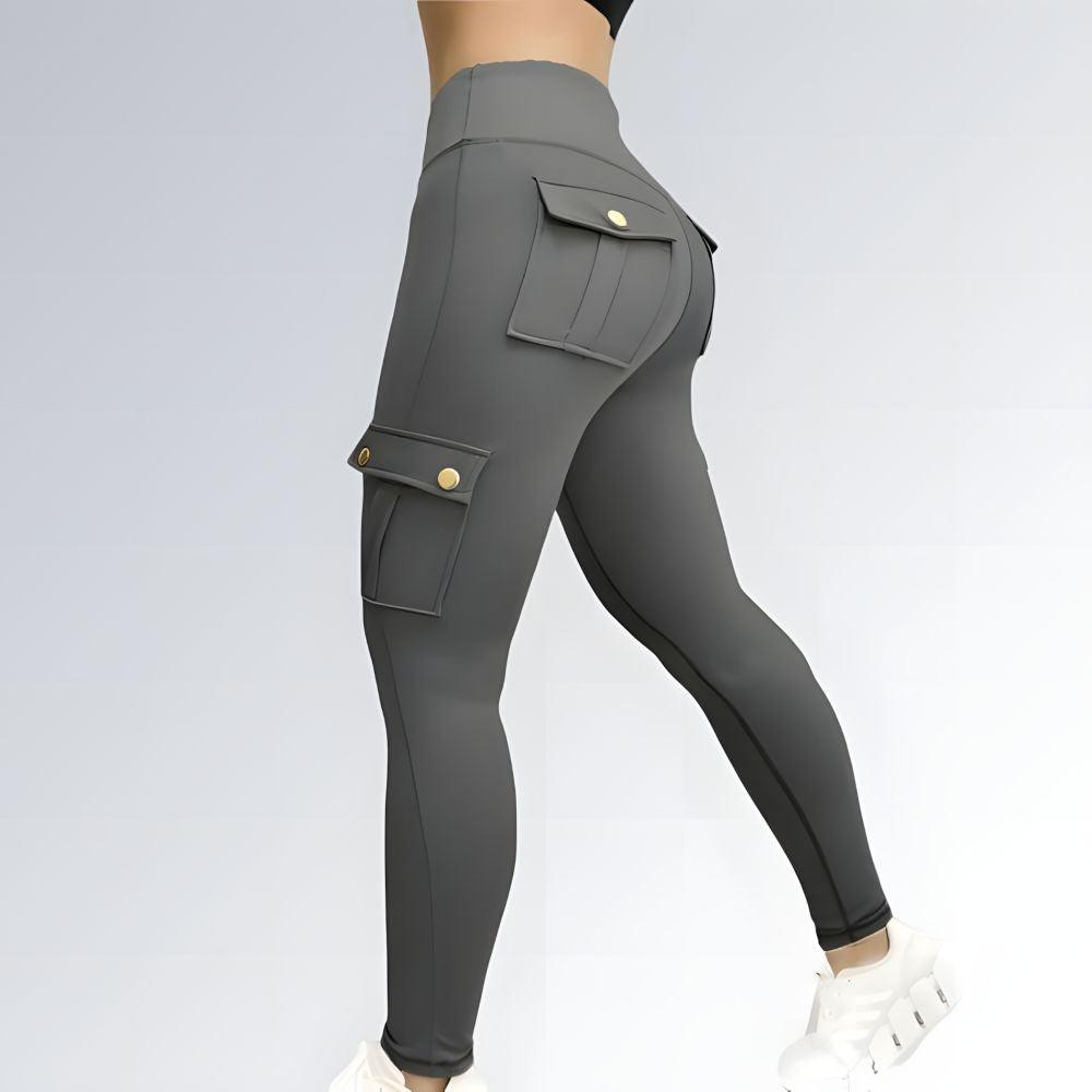 Calça legging feminina estilo gym com cintura alta, cor cinza escuro e bolsos utilitários laterais.