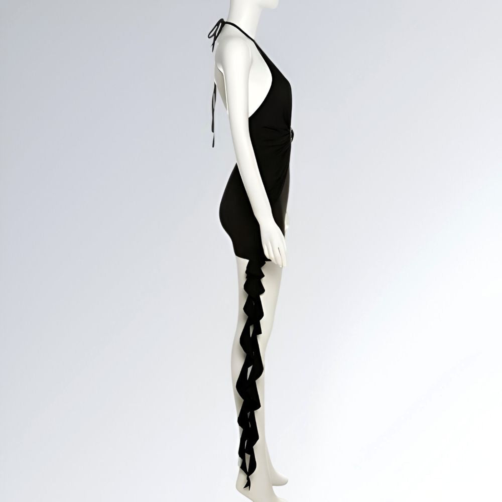 Mini vestido feminino preto com decote profundo, detalhe plissado lateral, alça pescoço e cauda assimétrica.