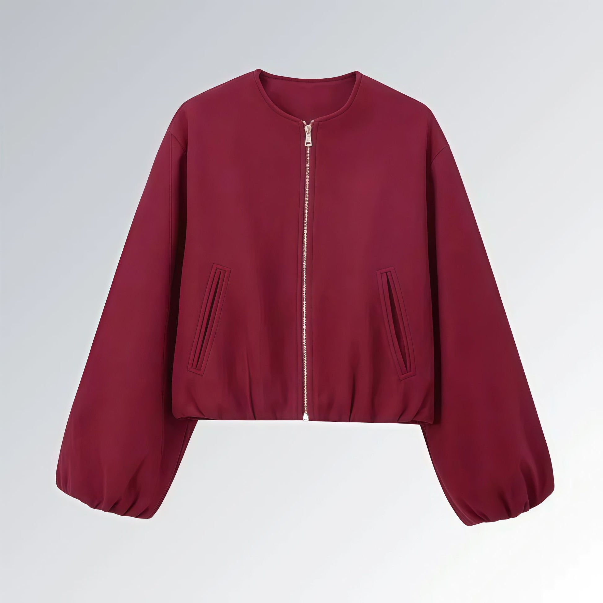 Jaqueta feminina vinho com zíper metálico, mangas bufantes e bolsos frontais, estilo casual streetwear para o outono.