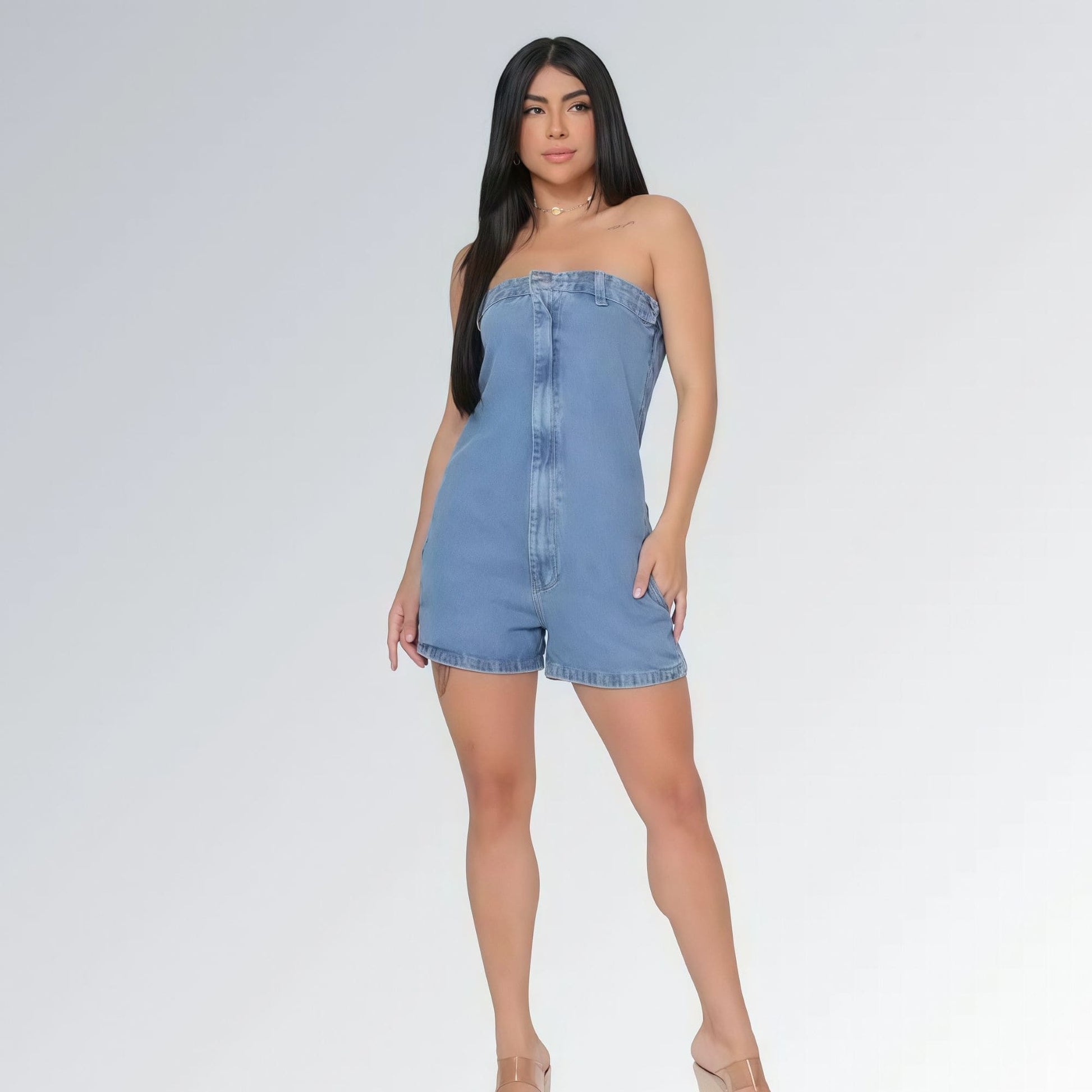 Macaquinho jeans feminino tomara que caia azul claro com bolsos laterais e detalhe de costura frontal, peça moderna disponível para venda online de moda casual.
