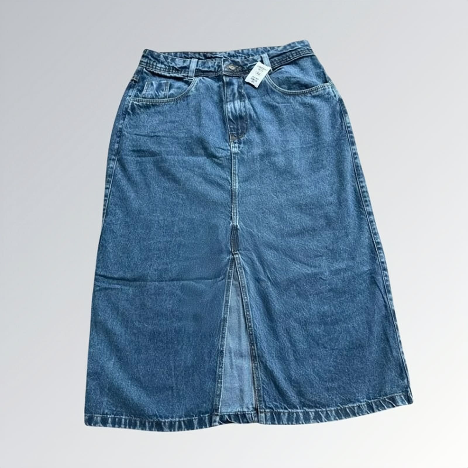 Saia jeans denim essential feminina azul com design clássico de cinco bolsos, fenda frontal e detalhe de costura central — peça versátil disponível para venda online de moda casual.